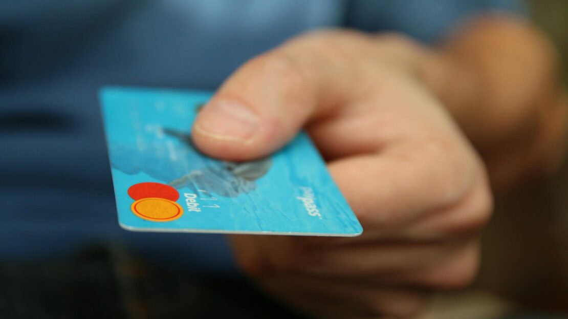 person holding debit card