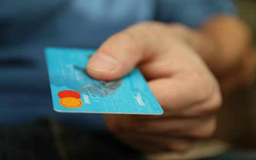 person holding debit card