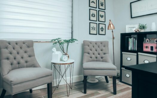 gray chairs near white round table in psychotherapist office