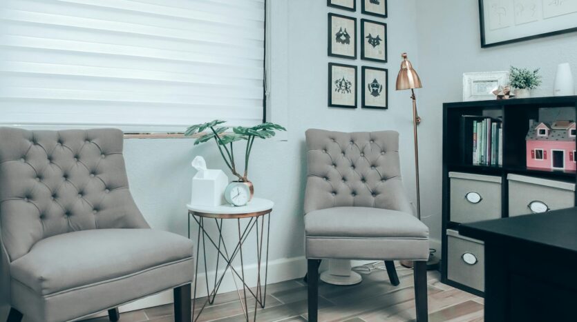 gray chairs near white round table in psychotherapist office